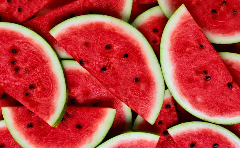 Lots of slices of cut watermelon grown from seed filling the frame